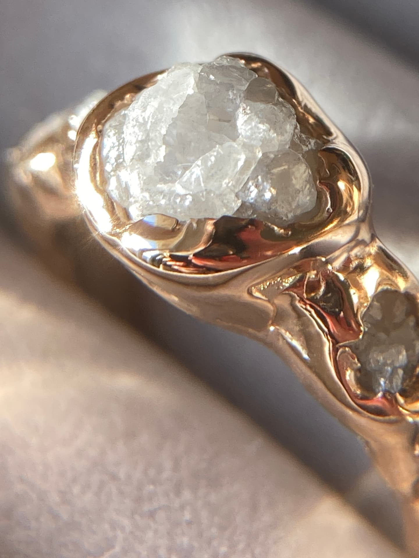 Bespoke gold ring set with a raw gemstone
